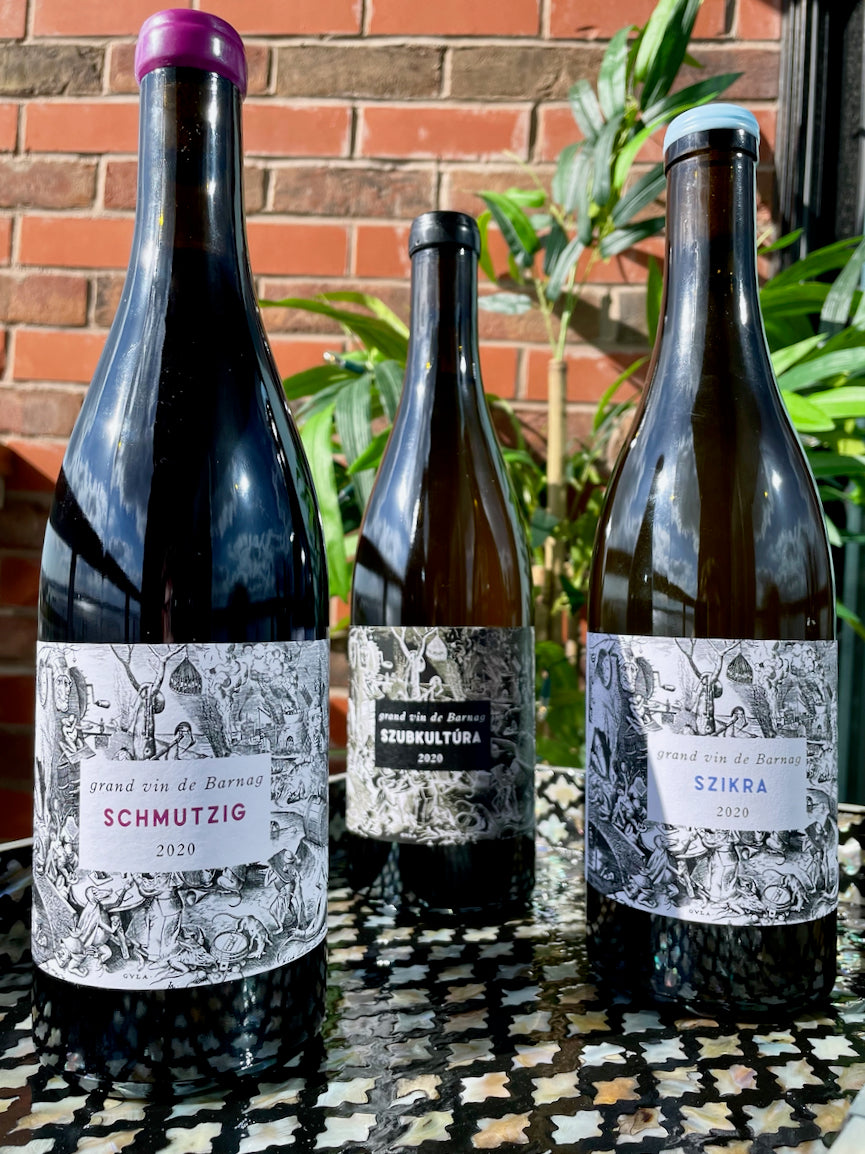 A line up of 3 Grand Vin de Barnag wine bottles, from left to right; Schmutzig, Szubkultura and Szikra.