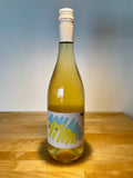 Martin Obenaus MO:Weiss with a light shining down on the bottle showcasing a cloudy white wine